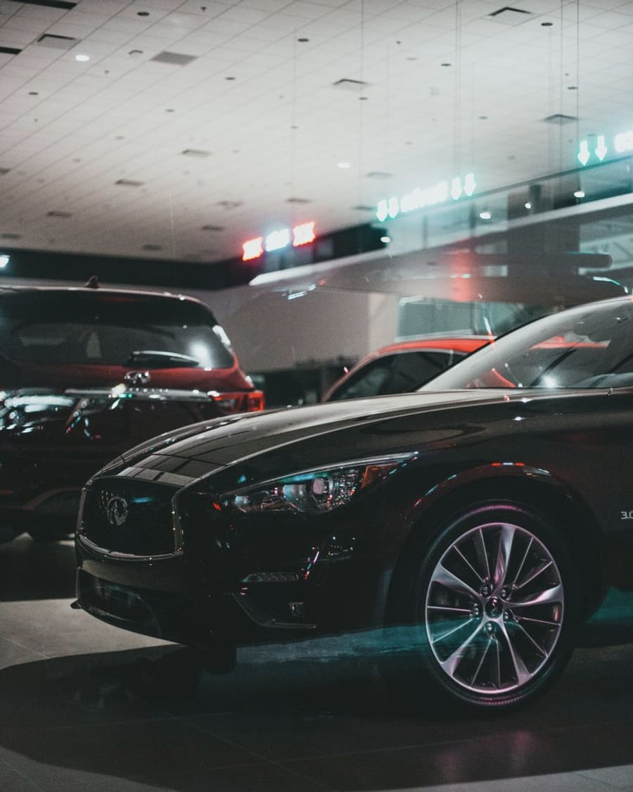 Car dealership forecourt at dusk
